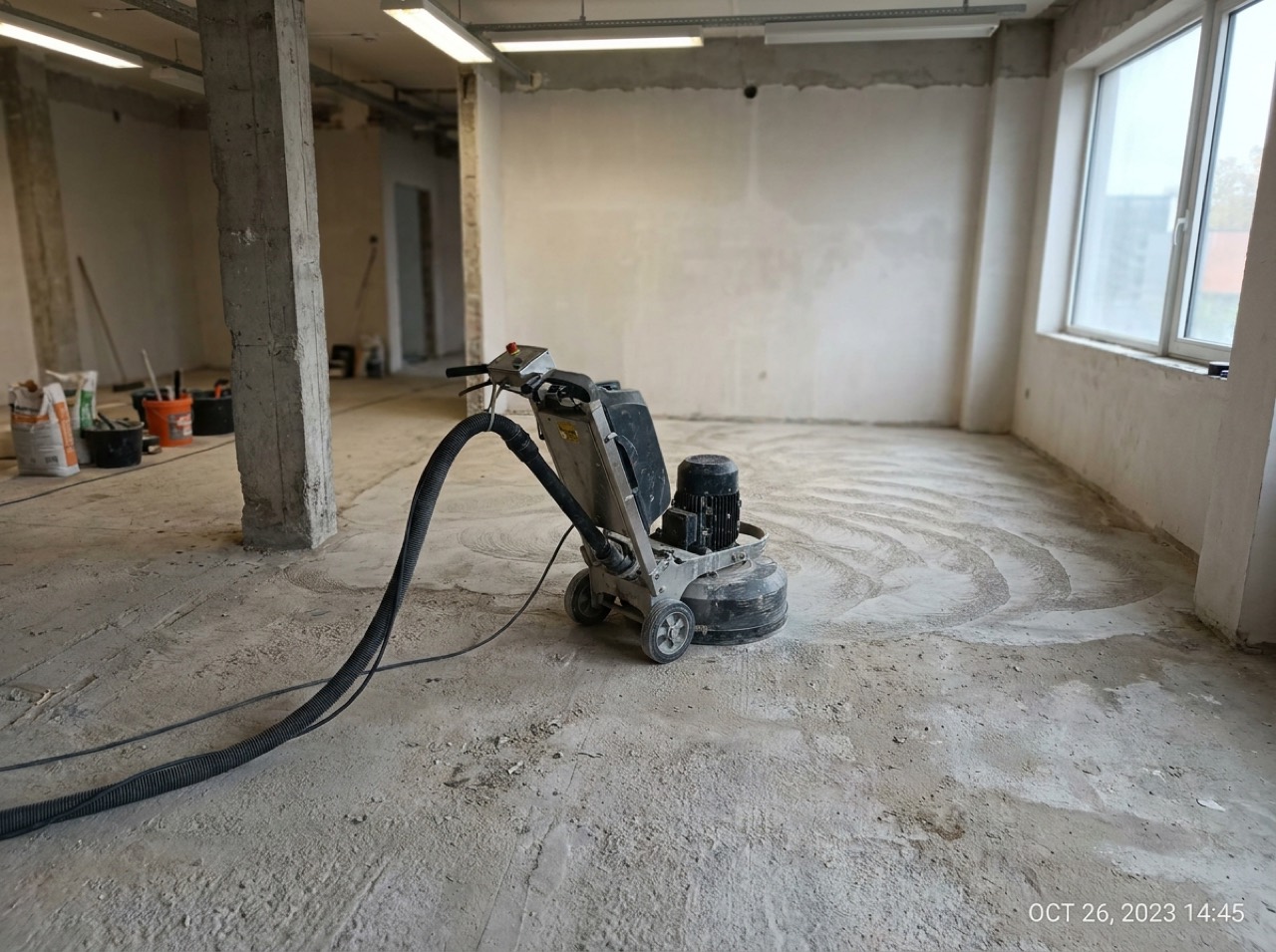 Walk-behind diamond grinder opening up a bare concrete slab