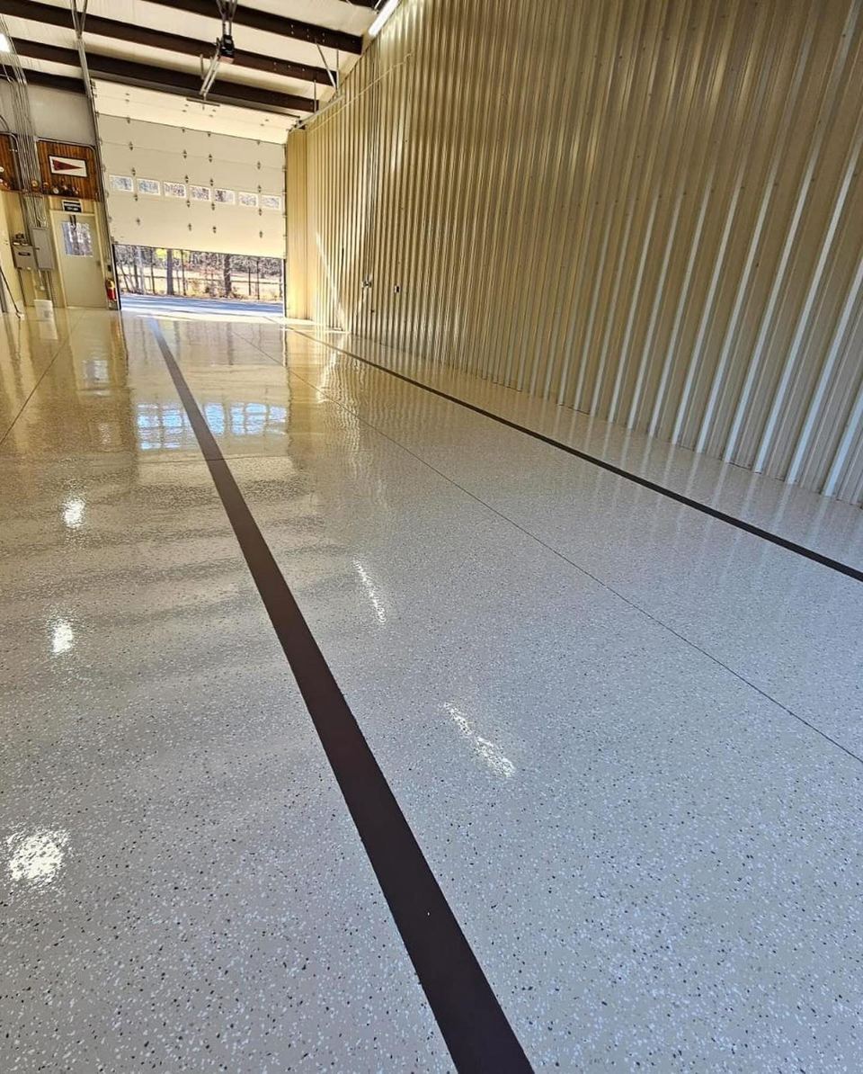 Light flake, steel building — a real floor finished by Epoxy Living